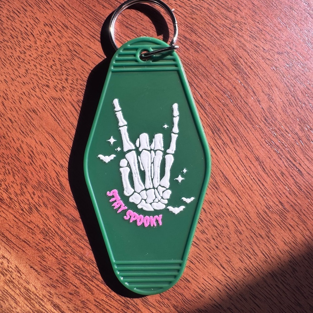 Stay Spooky Motel Keychain | Green | Skeleton Hand Rock Sign